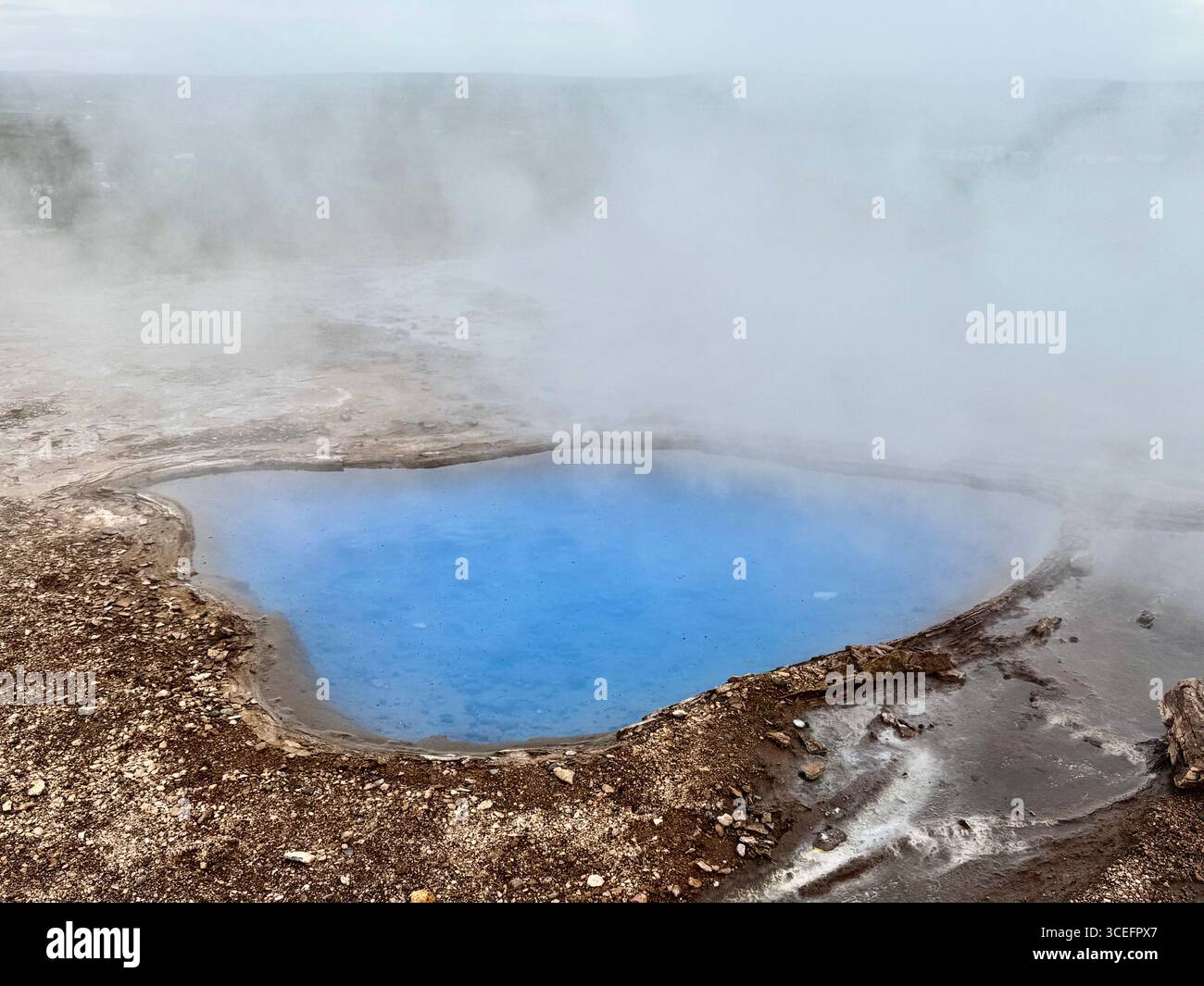 Milky bright blue, hot, steamy water of Blesi hot springs in Geysir Geothermal Area of Iceland. - Smartphone Captured Stock Image