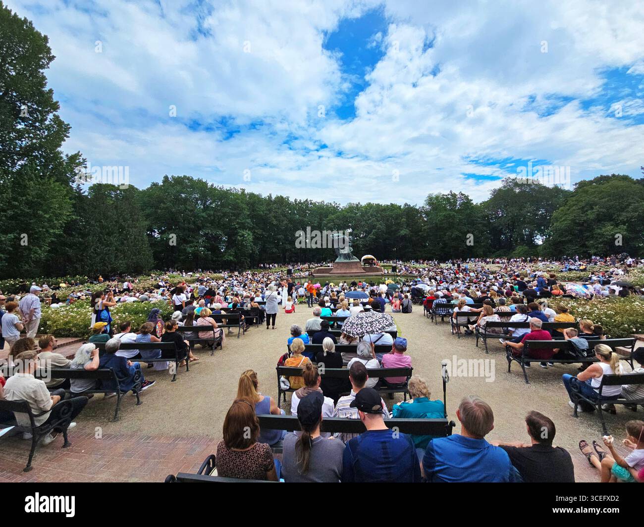A classical concert by the Fryderyk Chopin Monument at the Royal Baths Park in Warsaw, Poland. - Smartphone Captured Stock Image