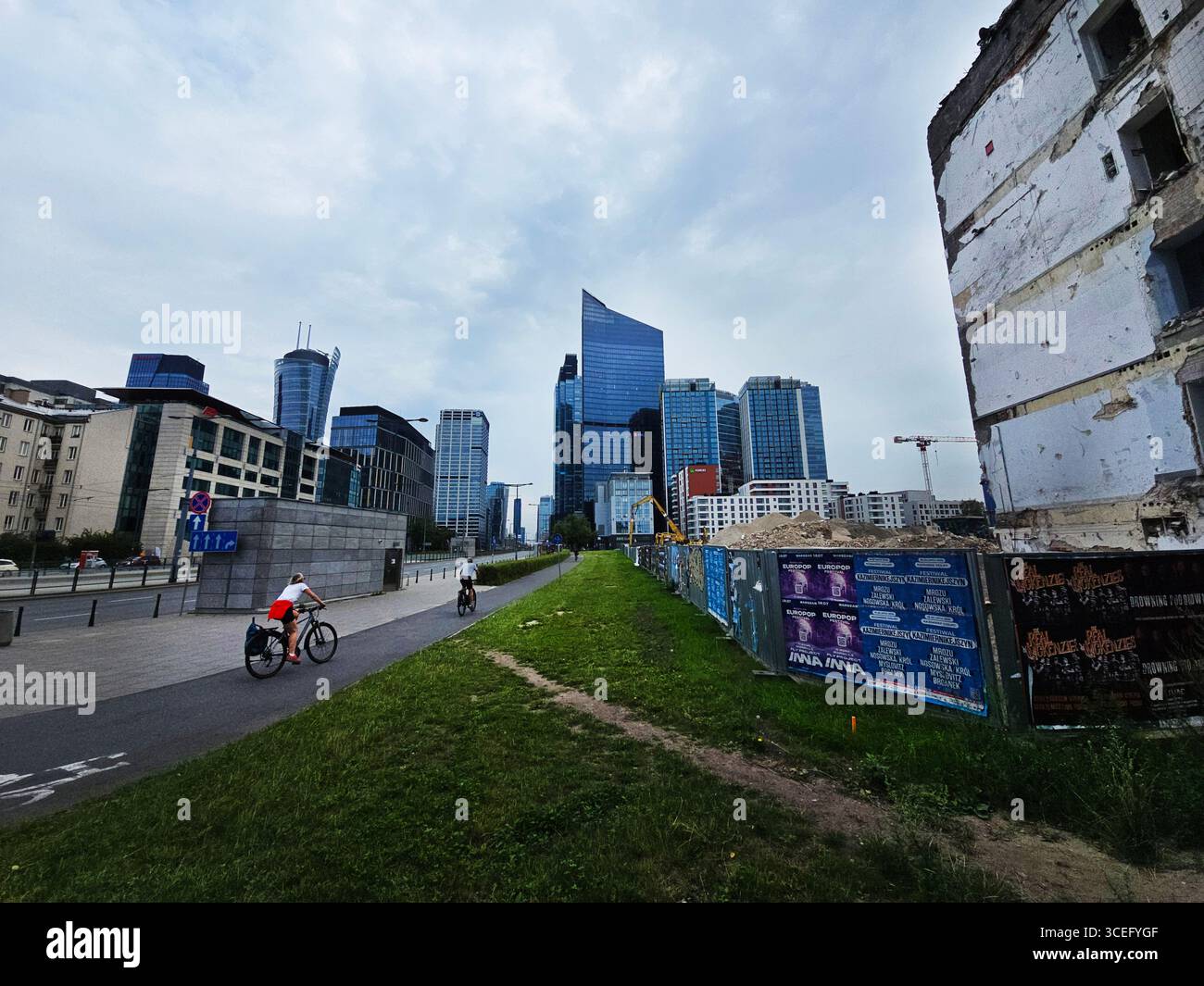 A woman cycling towards ' The Hub ' in Warsaw, Poland. - Smartphone Captured Stock Image