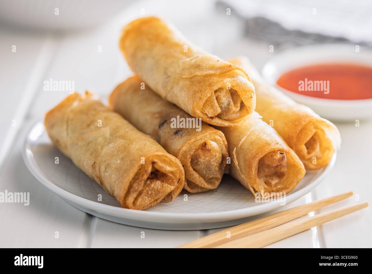 Fried spring rolls on plate on a white table. Stock Photo