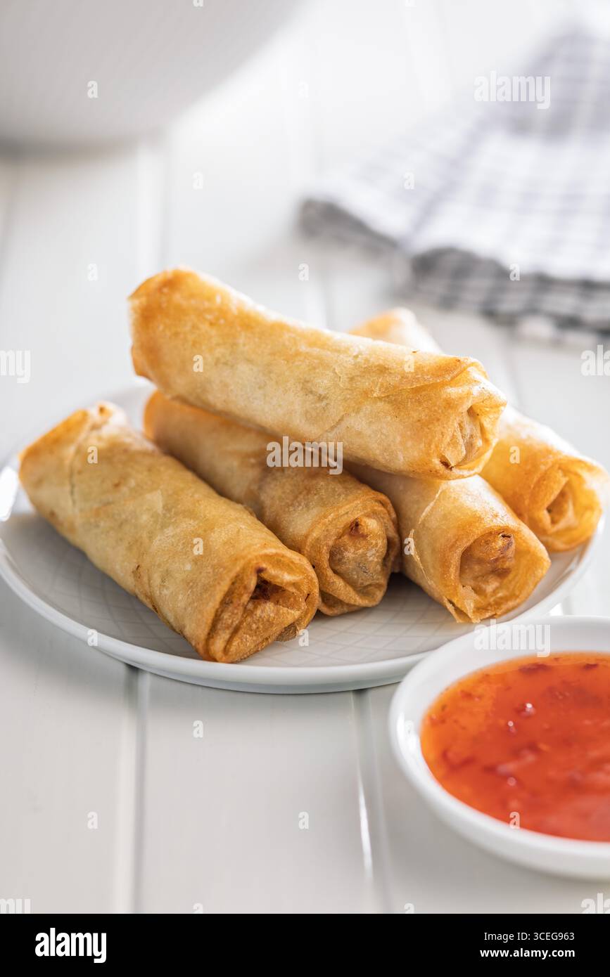 Fried spring rolls on plate on a white table. Stock Photo