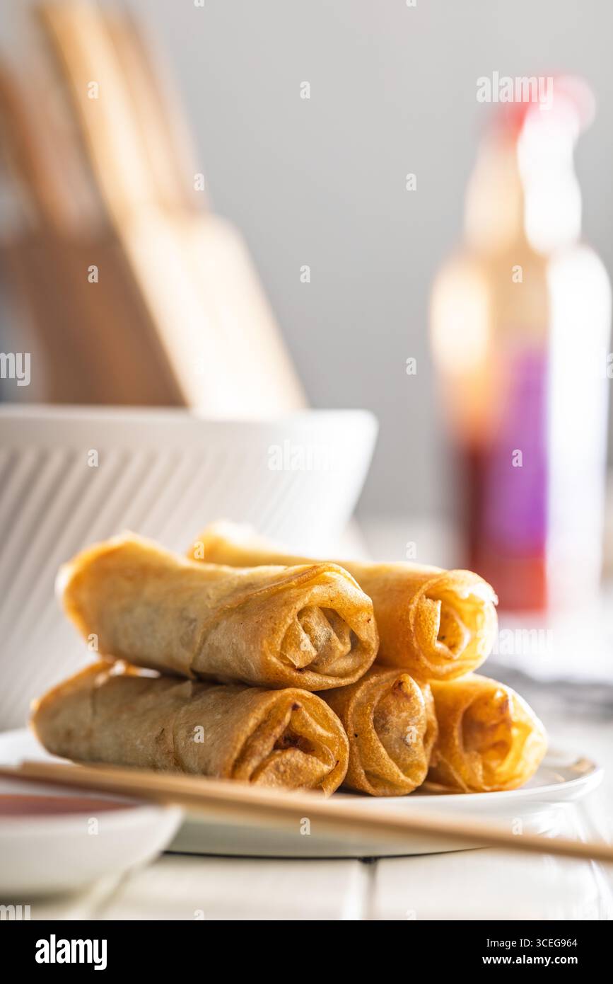 Fried spring rolls on plate on a white table. Stock Photo