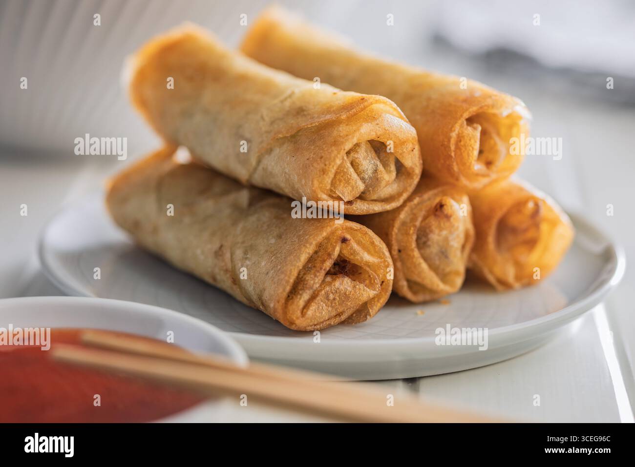 Fried spring rolls on plate on a white table. Stock Photo