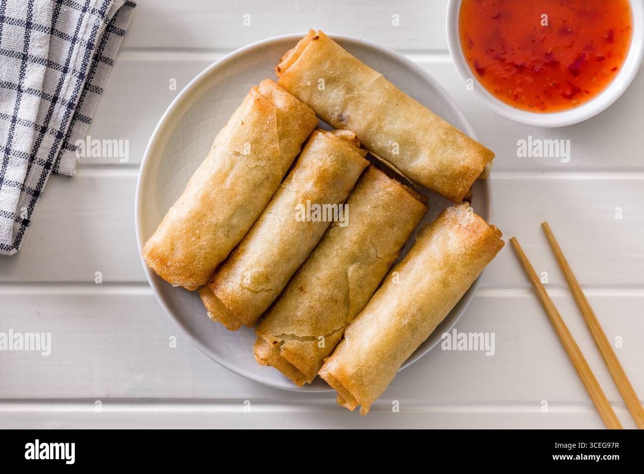 Fried spring rolls on plate on a white table. Top view. Stock Photo