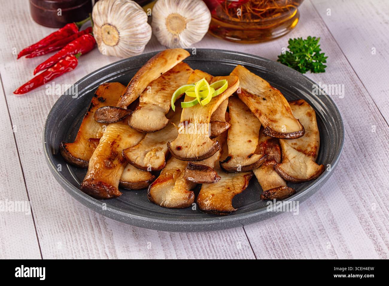 Vegan cuisine - Roasted eringi mushrooms in the plate Stock Photo - Alamy