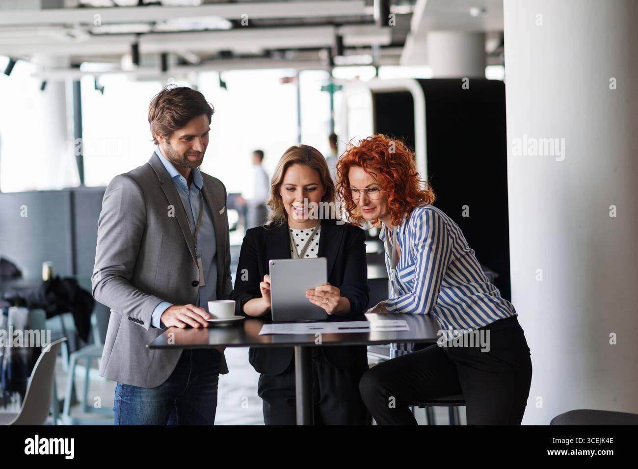 Creative team having discussion over coffee about project strategy. Stock Photo