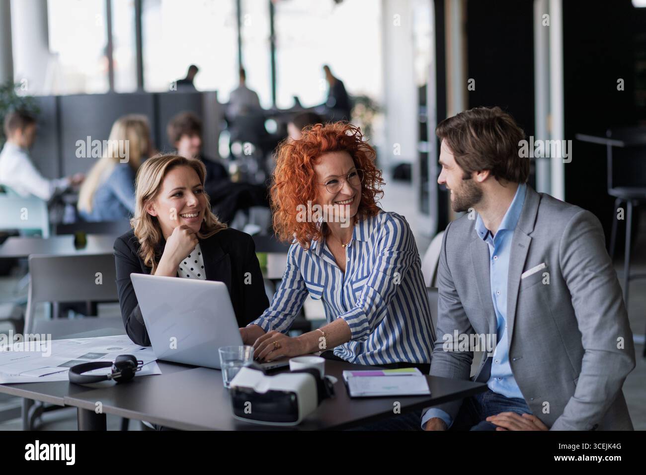 Creative team having discussion over coffee about project strategy. Stock Photo