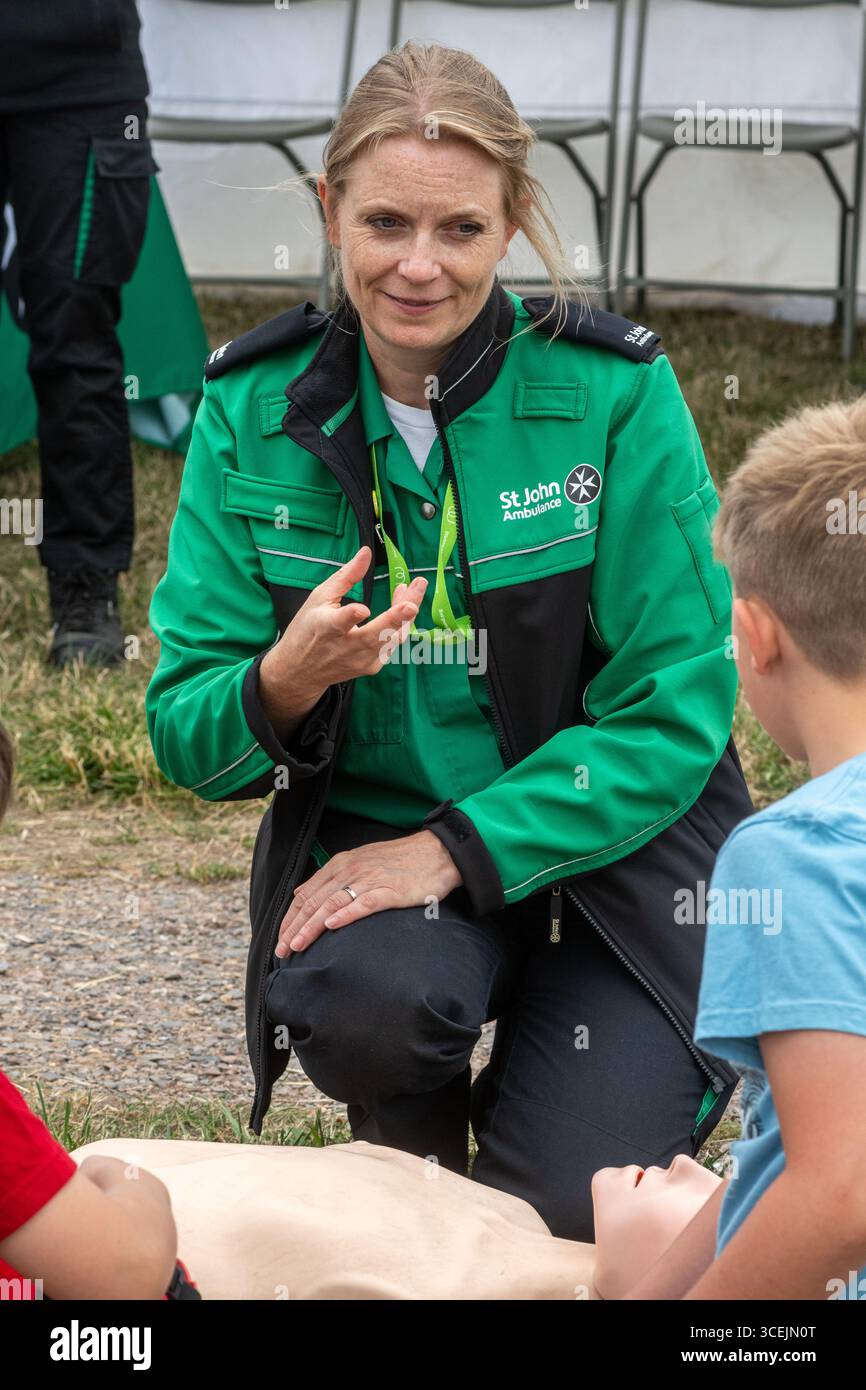 St John Ambulance volunteer teaching or demonstrating CPR ...