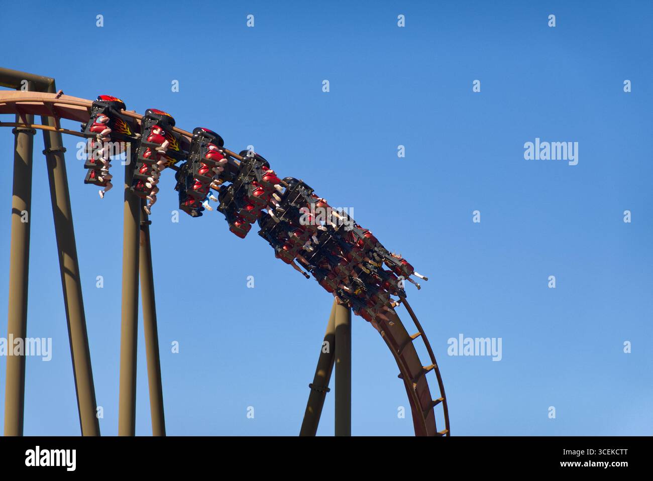 Passengers hanging upside down on inverted roller coaster ride at ...