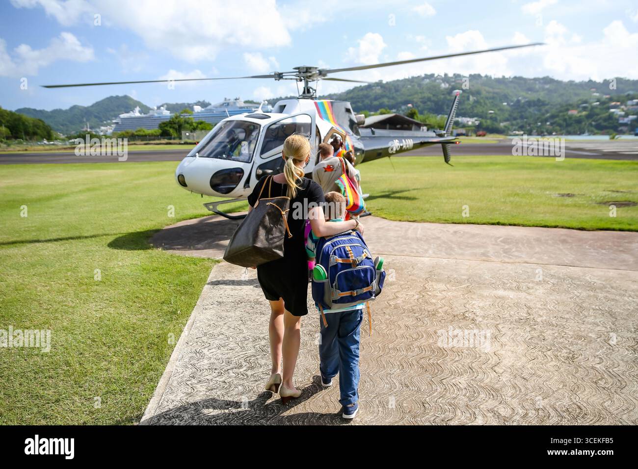 Morgan Bay, Saint Lucia - January 2, 2016: Family boarding a private helicopter transfer from Castries airport, Saint Lucia, Caribbean. Stock Photo