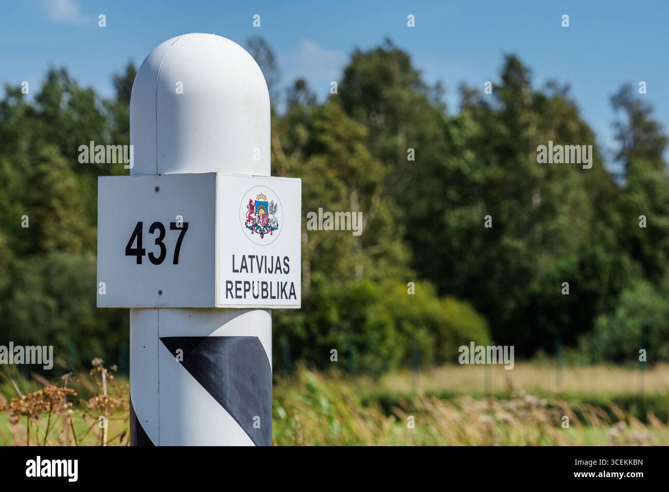 Latvian border post displaying the national emblem and inscription LATVIJAS REPUBLIKA, Republic of Latvia Stock Photo
