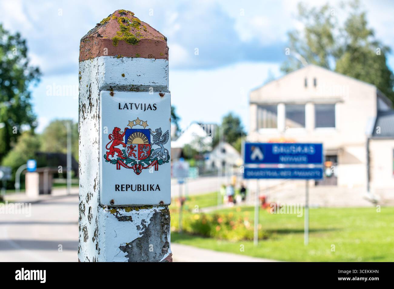 Weathered Latvian border post marked with the national coat of arms and the inscription LATVIJAS REPUBLIKA, Republic of Latvia Stock Photo