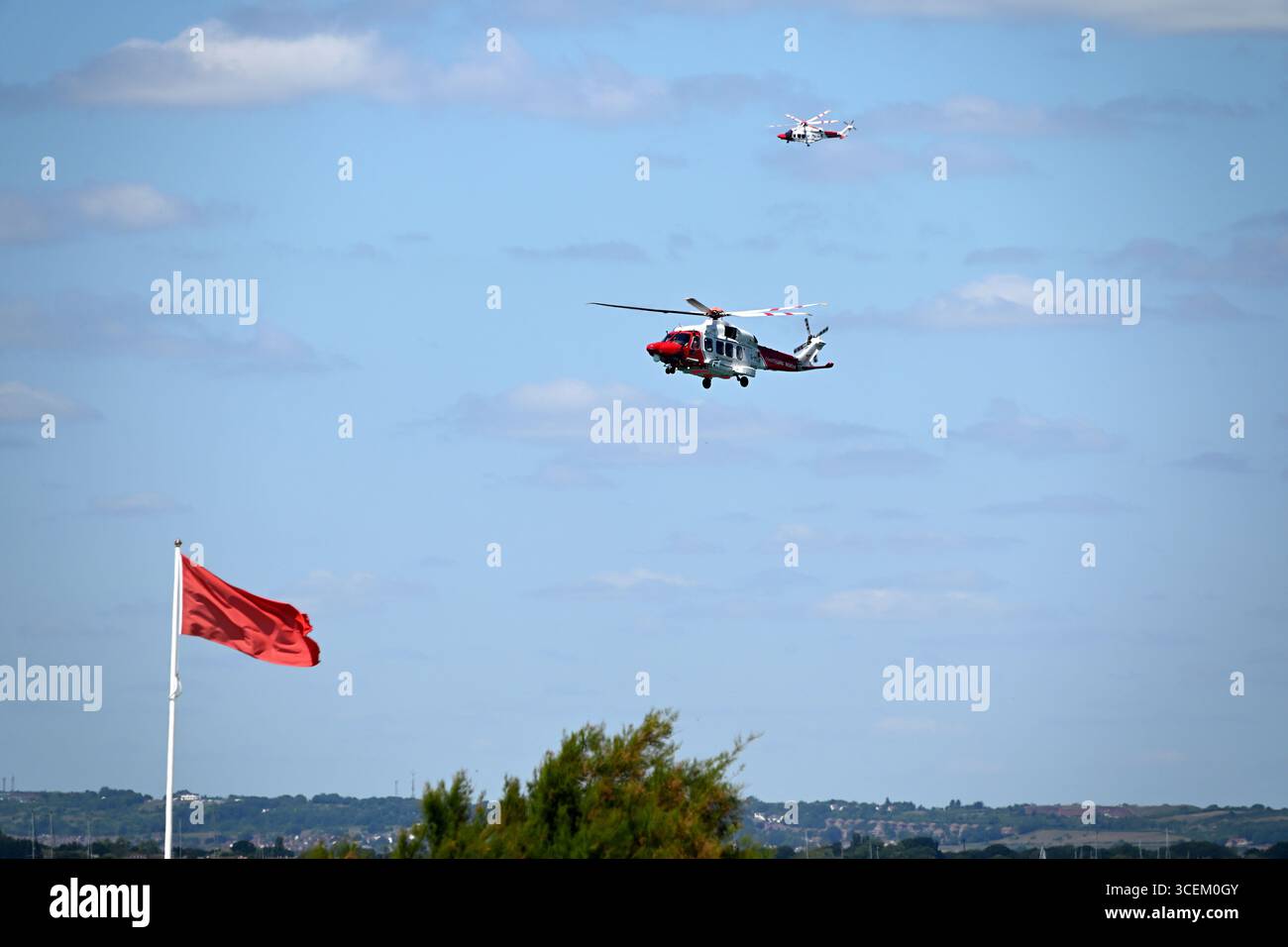 Two RNLI Helicopters performing a search and rescue Stock Photo - Alamy