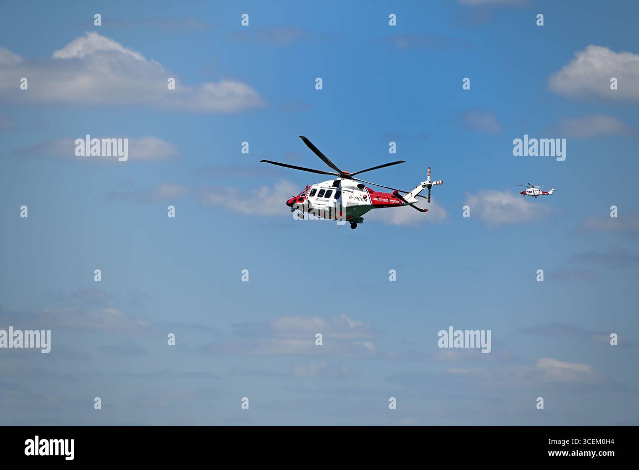 Two RNLI Helicopters performing a search and rescue Stock Photo - Alamy