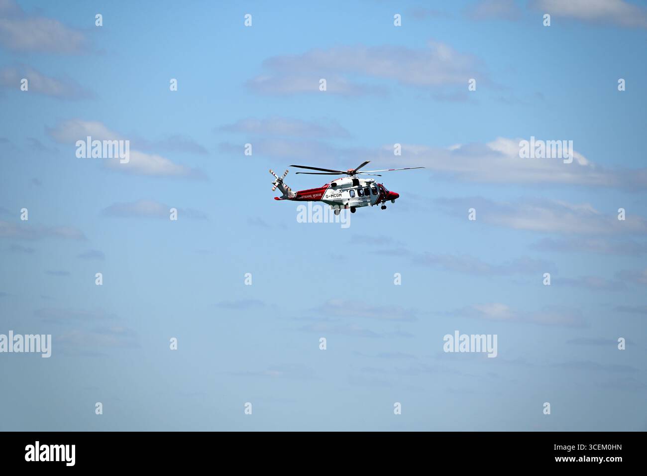RNLI Helicopter performing a search and rescue Stock Photo - Alamy