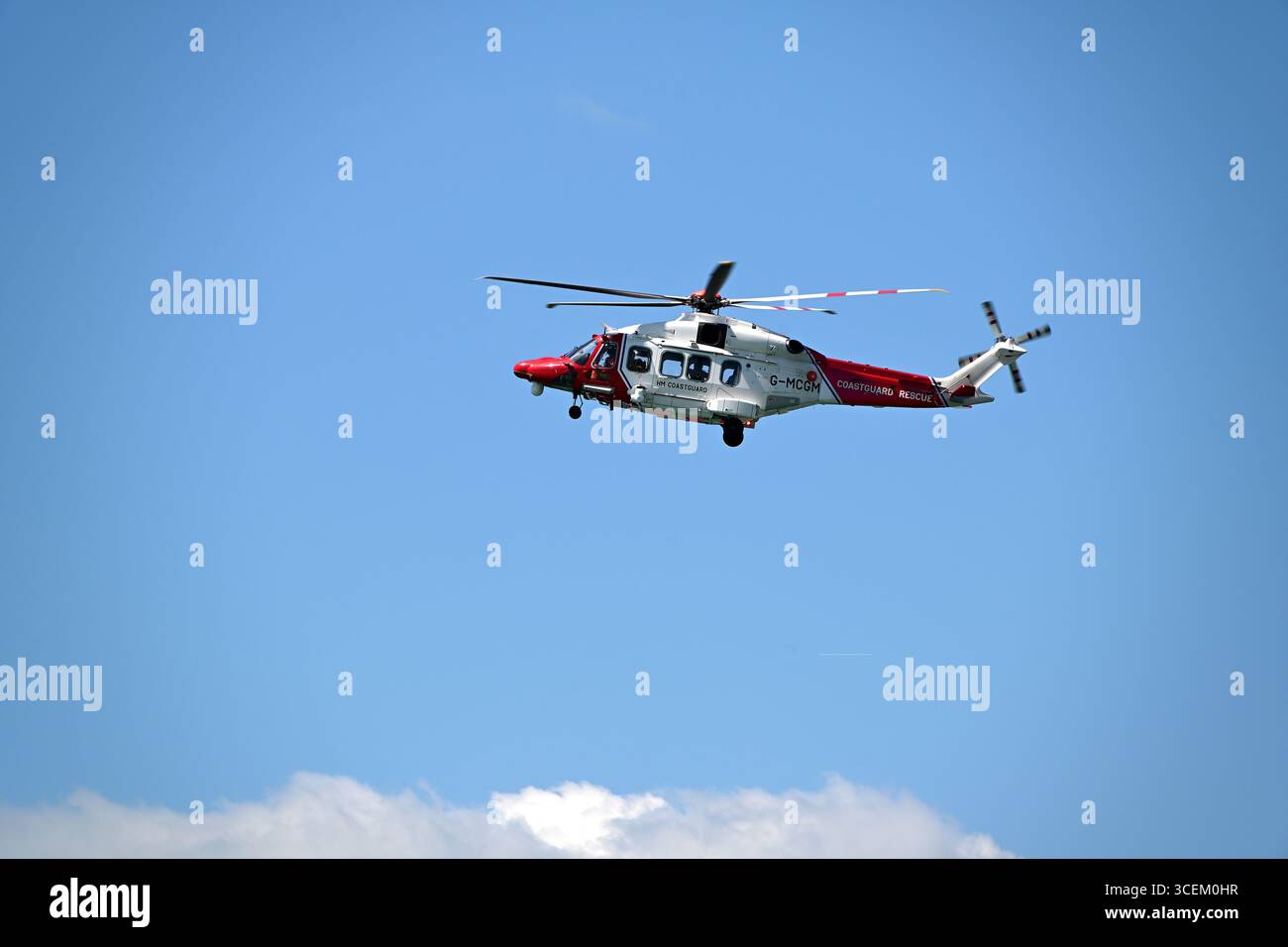 RNLI Helicopter performing a search and rescue Stock Photo - Alamy