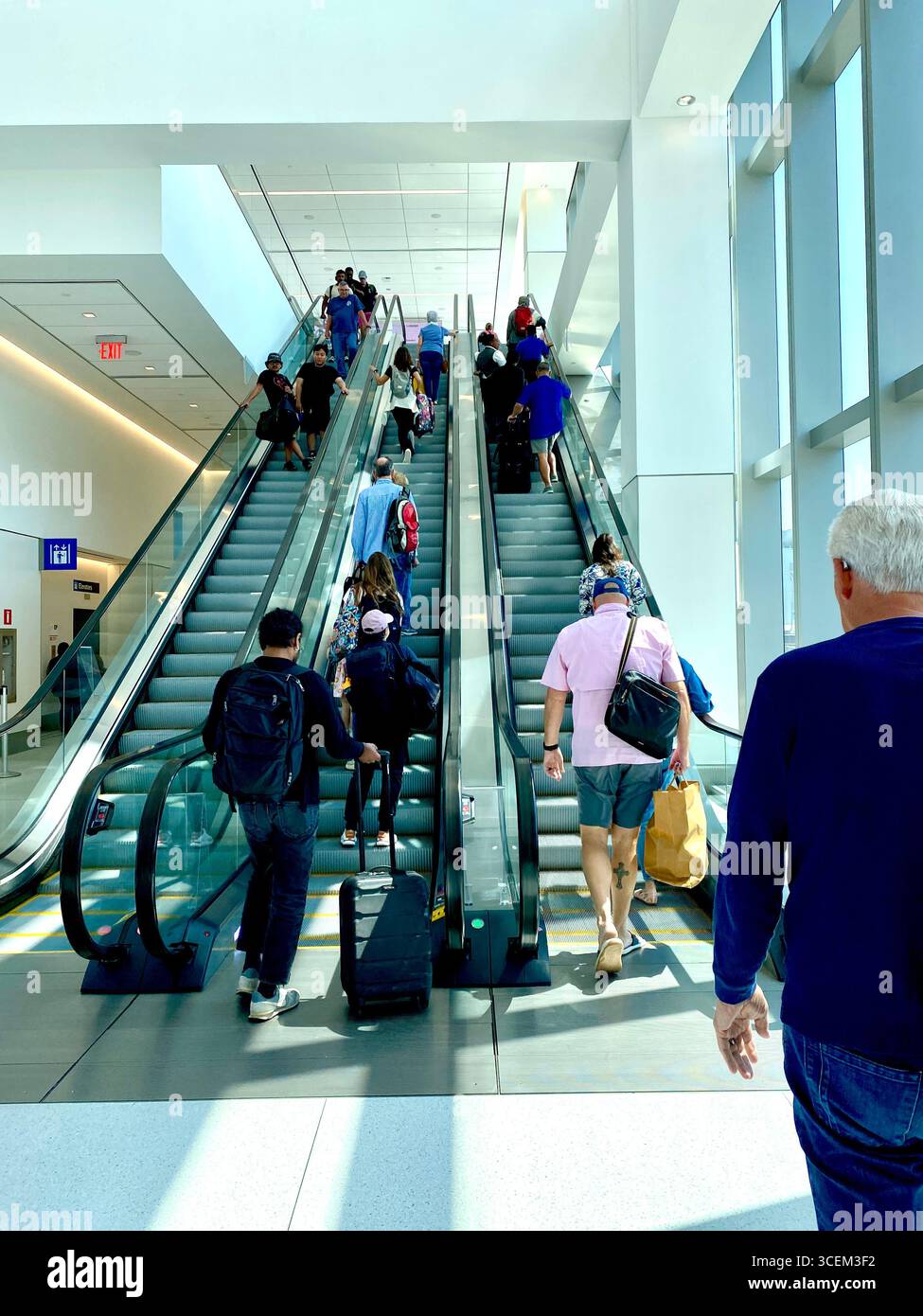 Escalator at Laguardia Airport, New York, 2025, going up with many people. - Smartphone Captured Stock Image