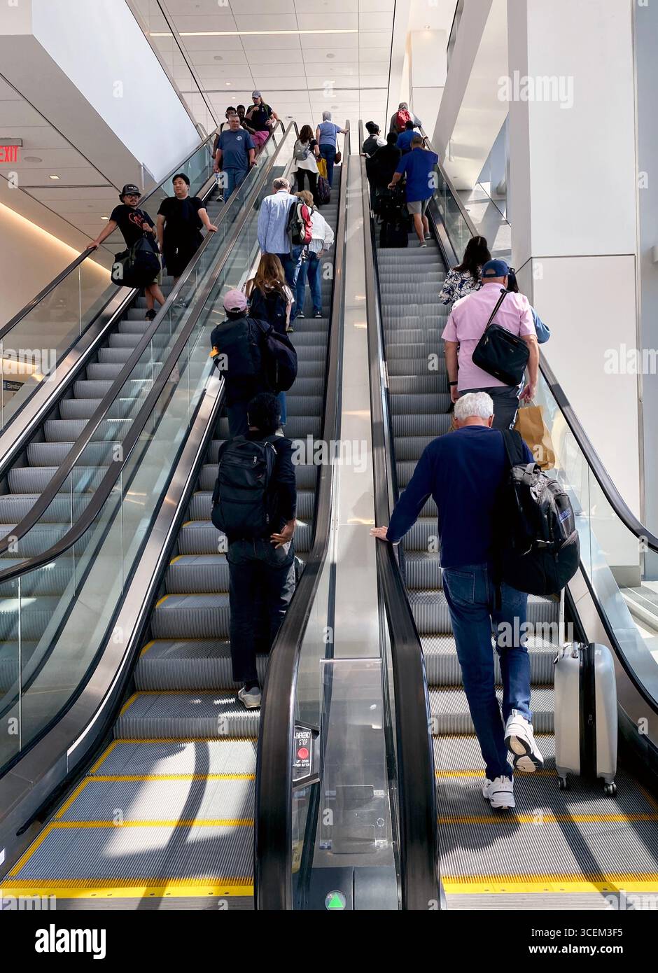 Escalator at Laguardia Airport, New York, 2025, going up with many people. - Smartphone Captured Stock Image