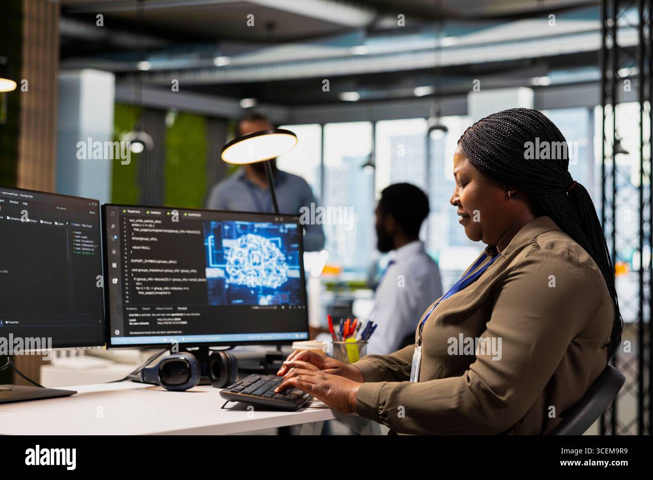System administrator in office using AI automation scripts to reduce repetitive coding tasks. Woman using artificial intelligence technology on PC in high tech startup workspace Stock Photo