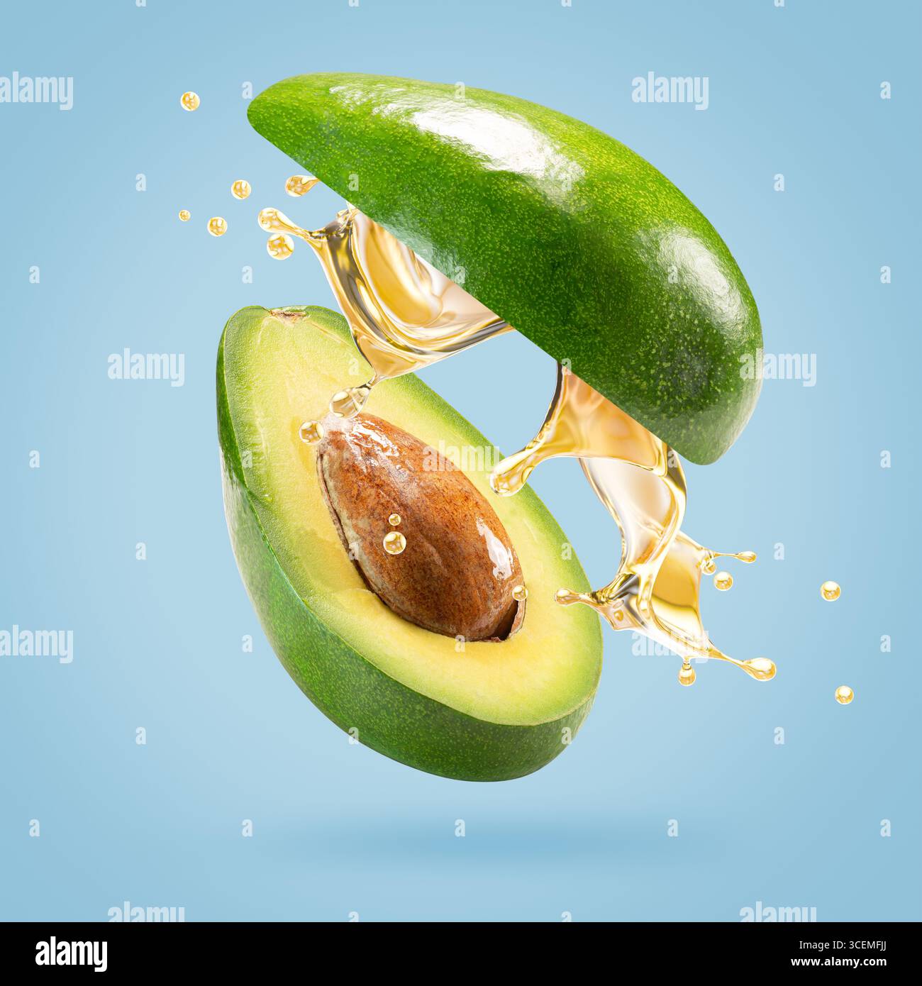 avocado with oil splash on a light blue background. Stock Photo