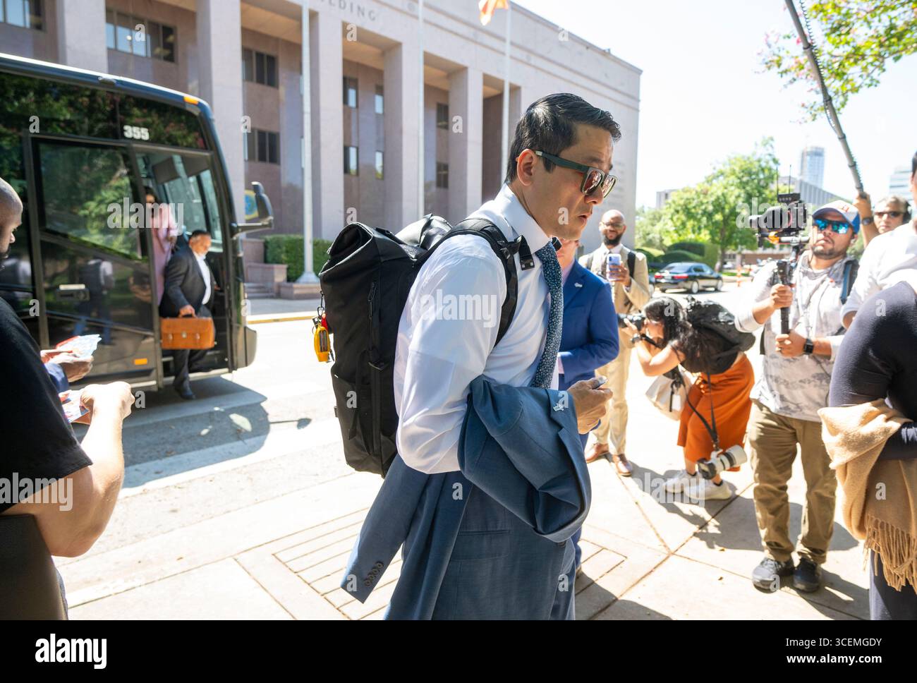Austin Texas USA, August 18 2025: Texas Democratic Caucus chair Gene Wu, D-Houston, gets off a charter bus from the Austin airport outside the State Archives building on the east side of the Texas Capitol upon their return to Austin following a two-week quorum break. Mandatory Credit: Bob Daemmrich/Alamy Live News Stock Photo