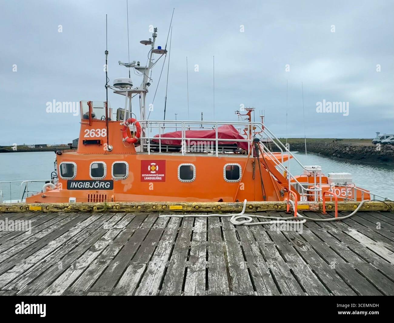 Orange vessel docked at the harbor in Hofn. - Smartphone Captured Stock Image