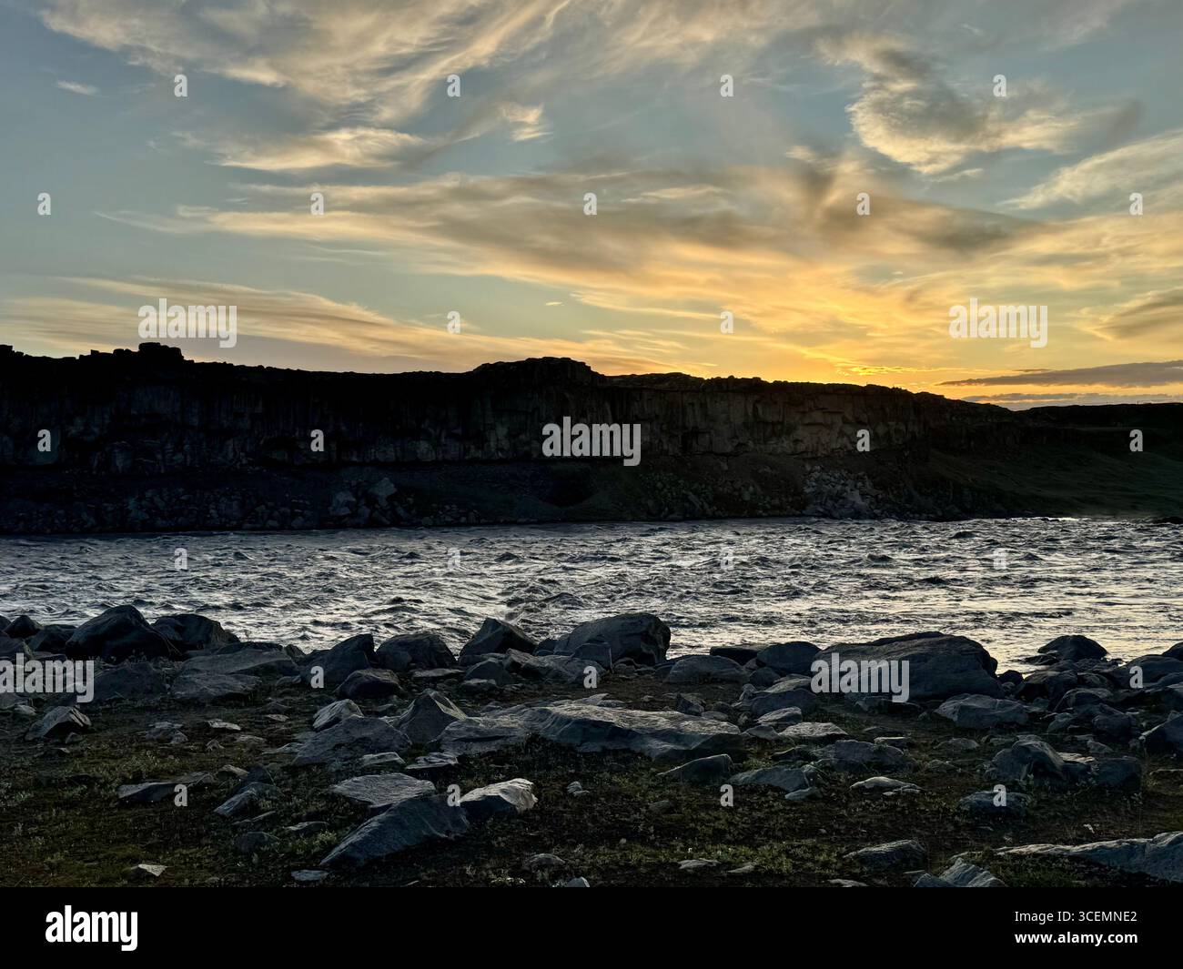 Sunset over the river creating shadows and silhouettes in the landscape - Smartphone Captured Stock Image