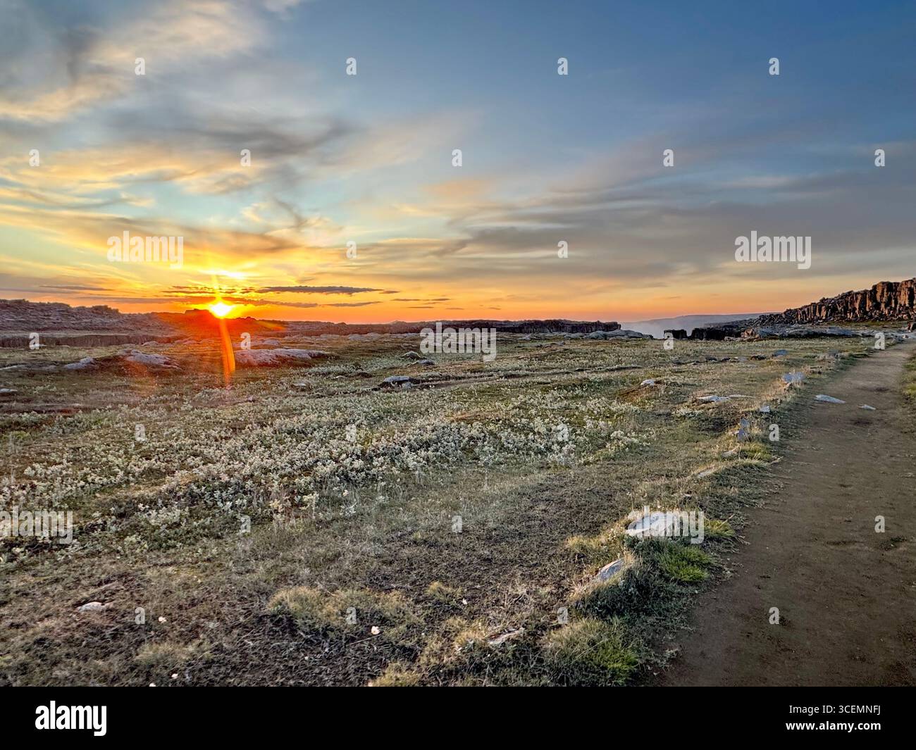 Glimpse of mist from Dettifoss waterfall in the background during golden hour. - Smartphone Captured Stock Image
