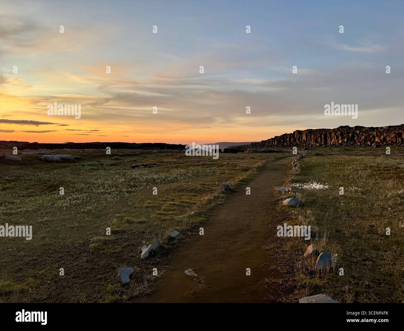 A late evening sunset washes over the basalt columns and trail between the Dettifoss and Selfoss waterfalls in July. - Smartphone Captured Stock Image