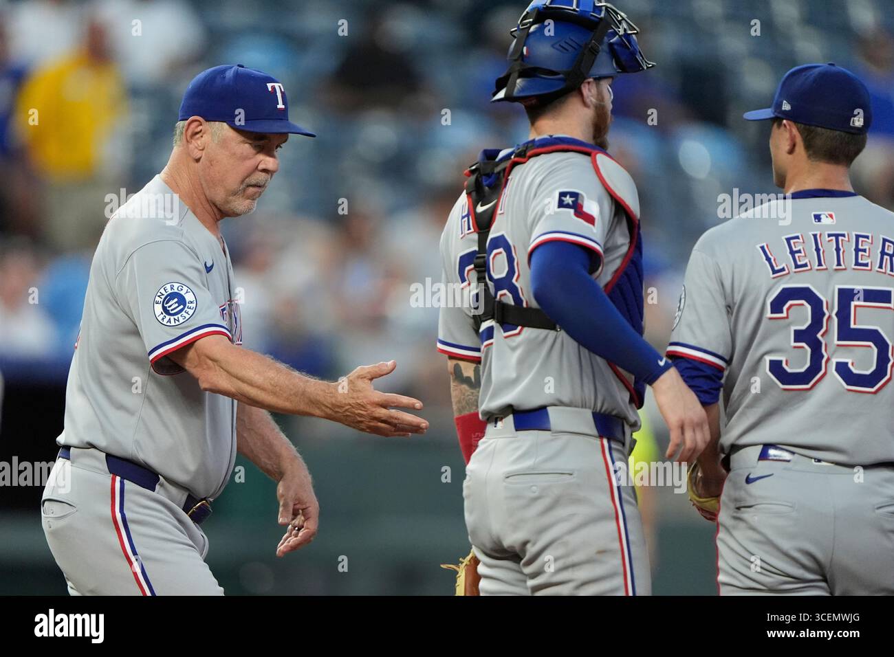 Texas Rangers manager Bruce Bochy, left, walks to the mound to make a ...