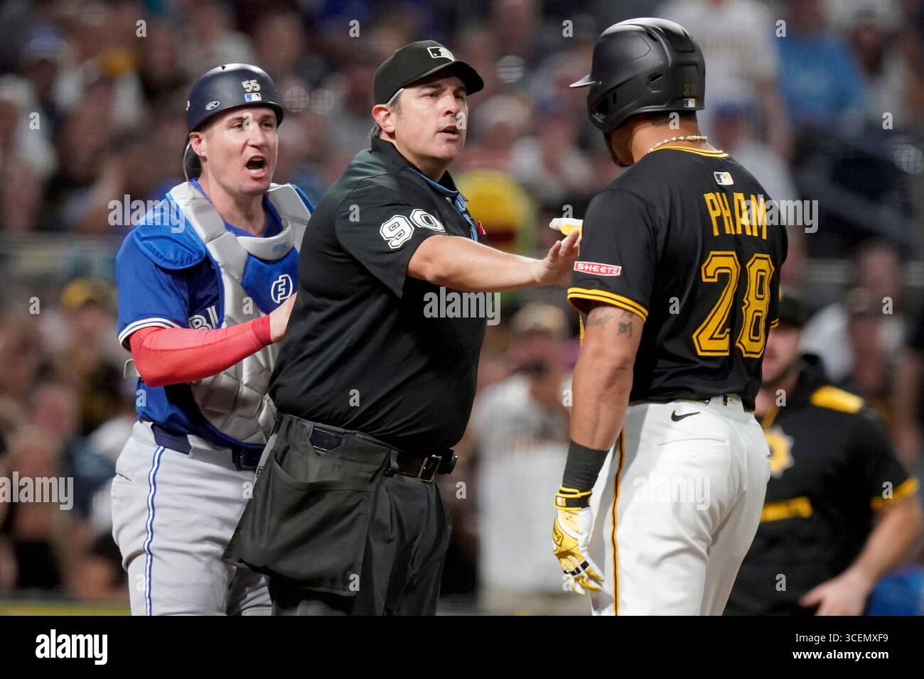 Home plate umpire Mark Ripperger, center, gets between Toronto Blue ...