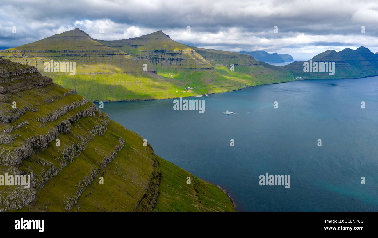 Aerial view of the majestic coastline where emerald slopes meet the ...
