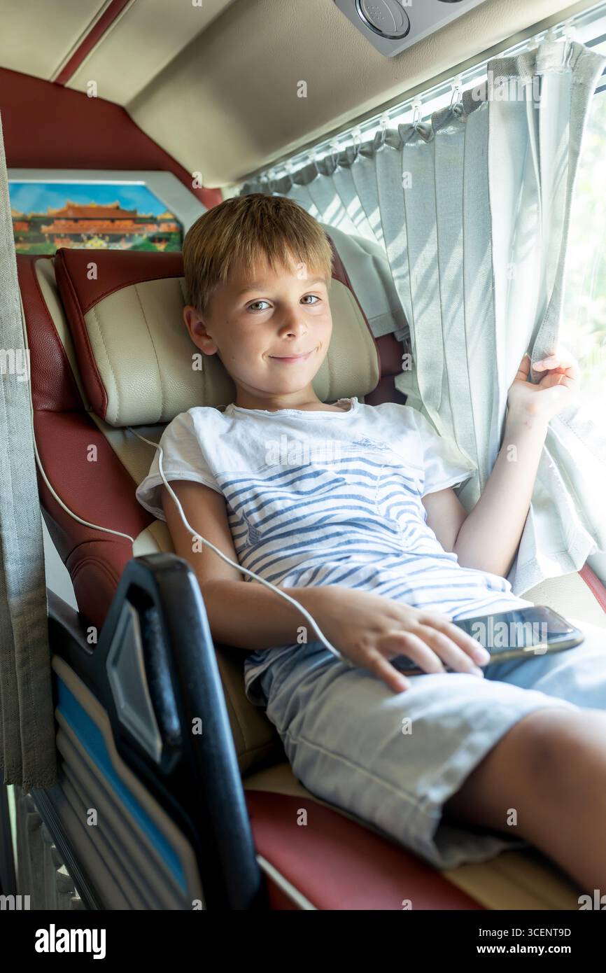 Child, boy, traveling in a sleeper bus in Vietnam, bed seat in the bus ...