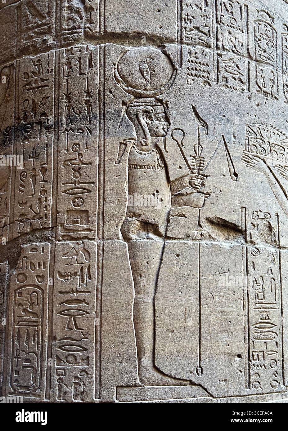 Relief carving of goddess Isis with hieroglyphs on a pillar at the ...