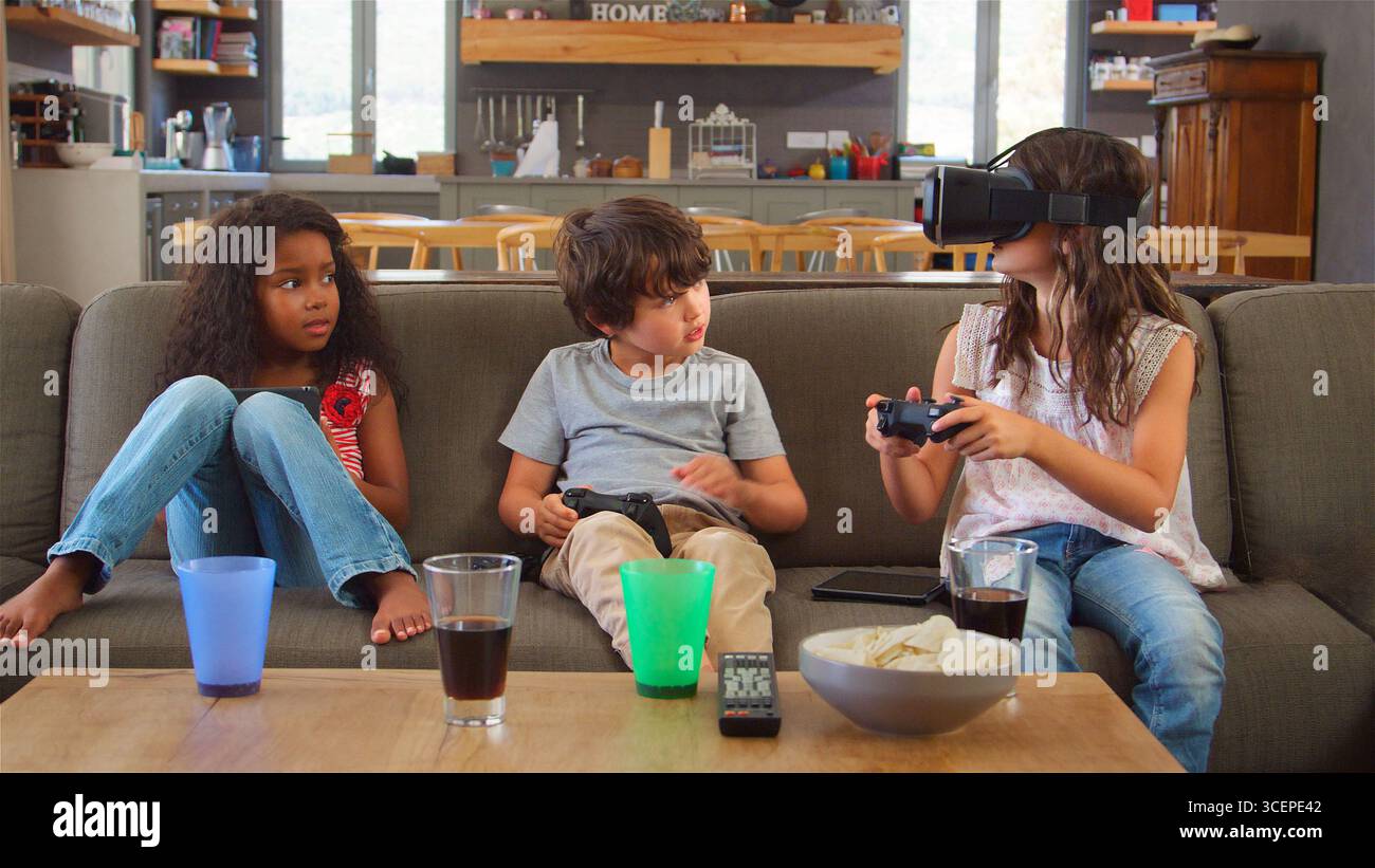 Children Play Computer Game Using Virtual Reality Headset Stock Photo