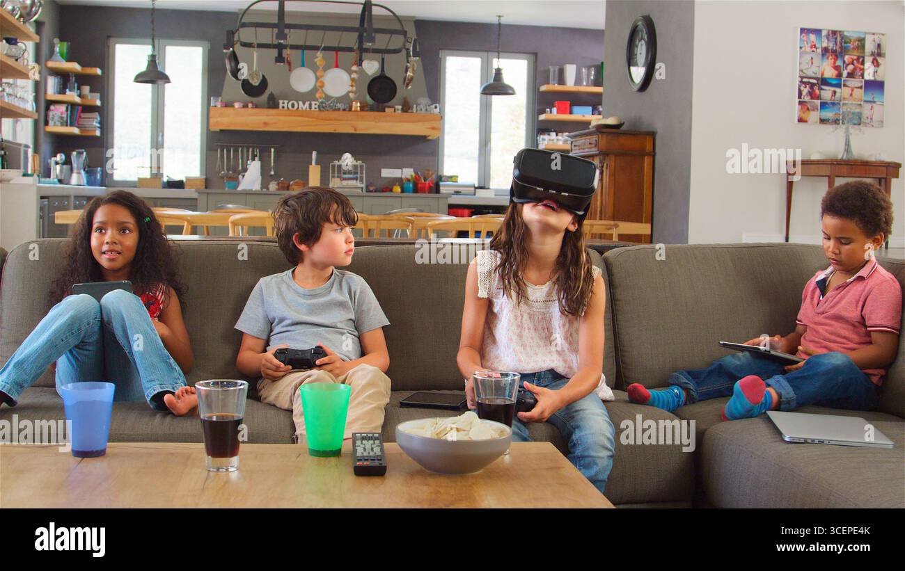Children Play Computer Game Using Virtual Reality Headset Stock Photo