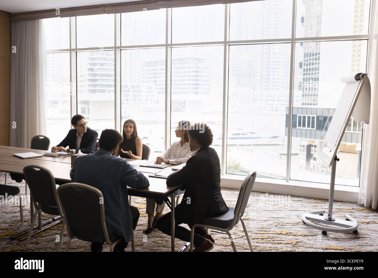 Diverse stakeholders group hold negotiations in round table format Stock Photo