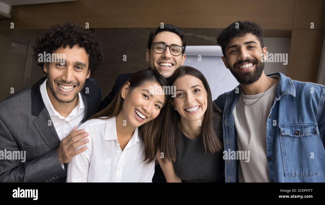 Group portrait diverse multiracial group five smiling friendly young people Stock Photo
