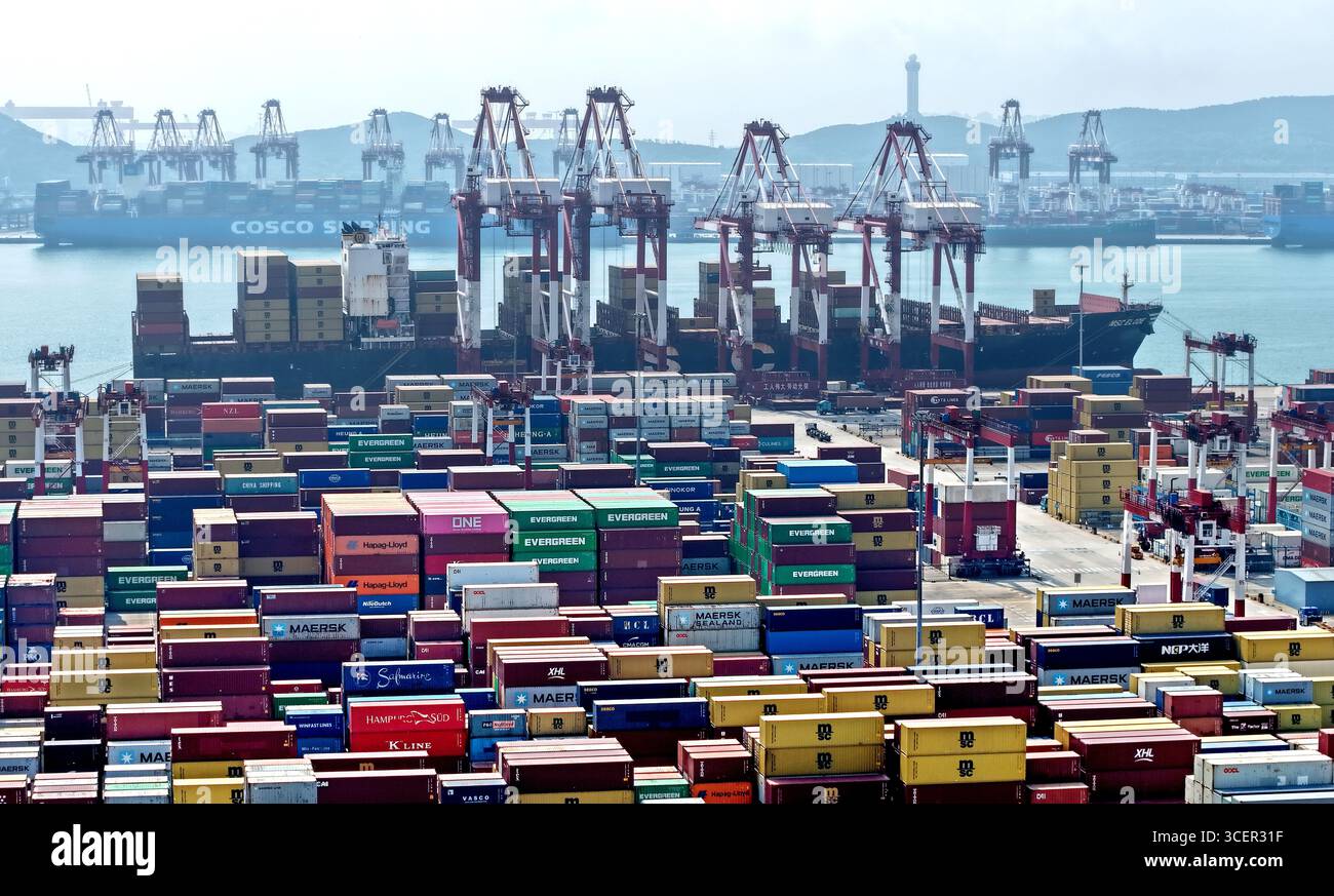 Qingdao. 19th Aug, 2025. An aerial drone photo taken on Aug. 19, 2025 shows a cargo ship at Qingdao Port in Qingdao, east China's Shandong Province. As of the end of July, Qingdao Port has added 22 new outbound trade routes this year, bringing its total to 233 and connecting to over 700 ports in more than 180 countries and regions. Credit: Li Ziheng/Xinhua/Alamy Live News Stock Photo
