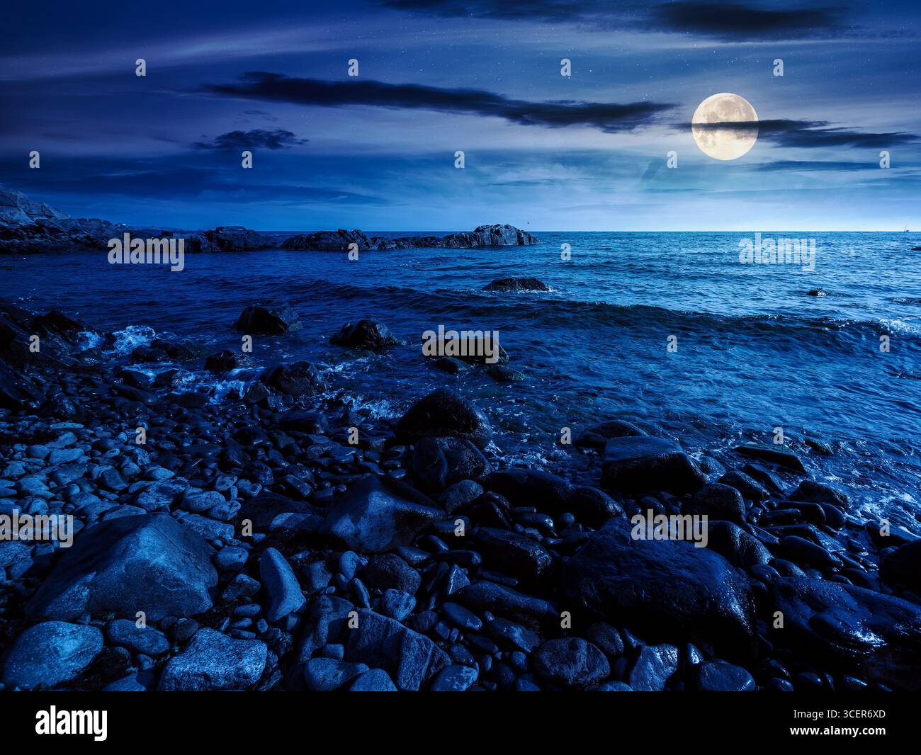 pebble coast at night. beautiful summer vacation season at the sea in full moon light Stock Photo