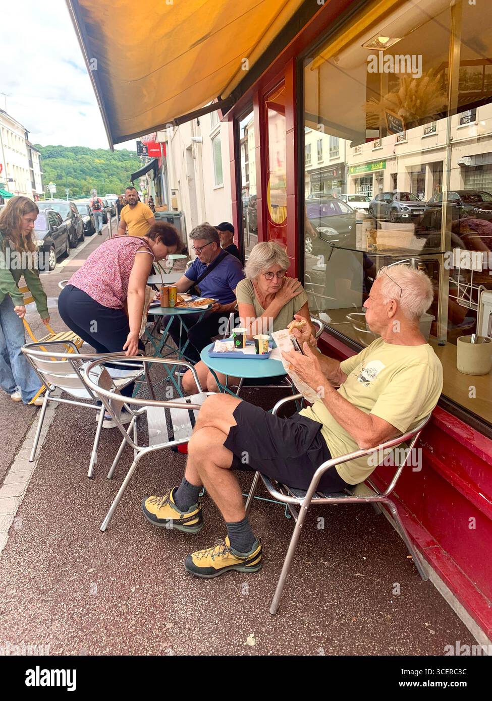 Vernon France shops shop tourists village town locals people cobbles cobbled restaurant eating food old style houses polar bear artwork sign signs - Smartphone Captured Stock Image