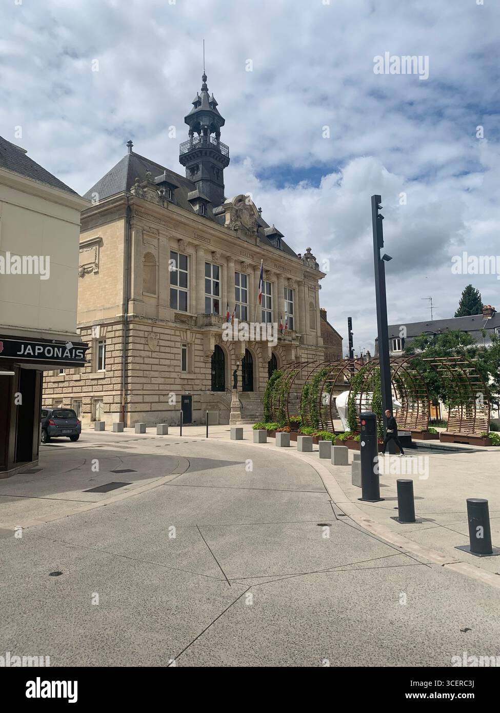 Vernon France shops shop tourists village town locals people cobbles cobbled restaurant eating food old style houses polar bear artwork sign signs - Smartphone Captured Stock Image