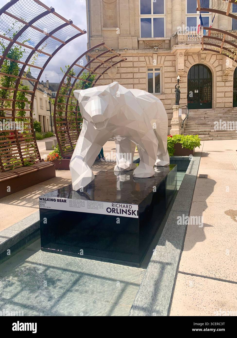 Vernon France shops shop tourists village town locals people cobbles cobbled restaurant eating food old style houses polar bear artwork sign signs - Smartphone Captured Stock Image