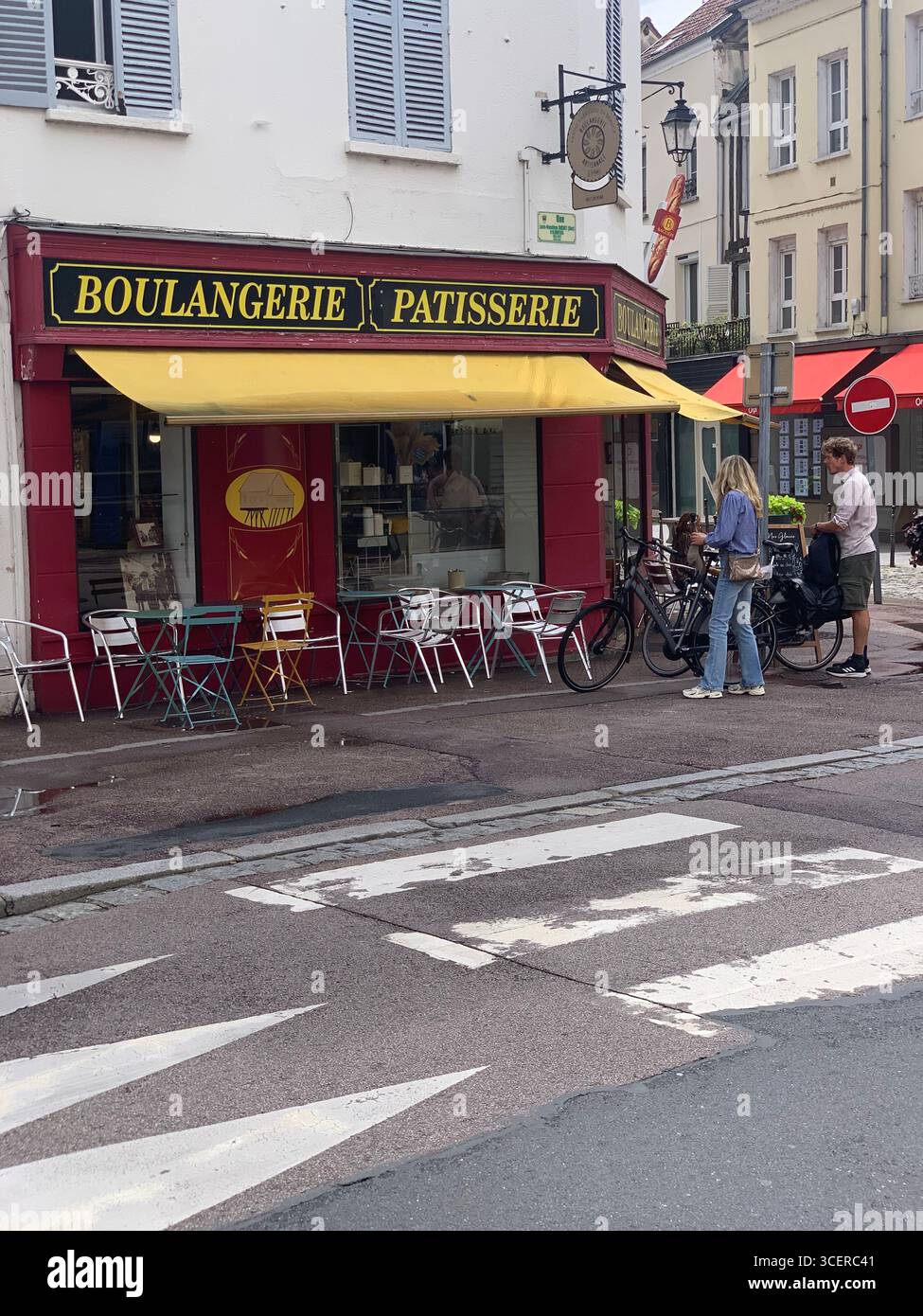 Vernon France shops shop tourists village town locals people cobbles cobbled restaurant eating food old style houses polar bear artwork sign signs - Smartphone Captured Stock Image