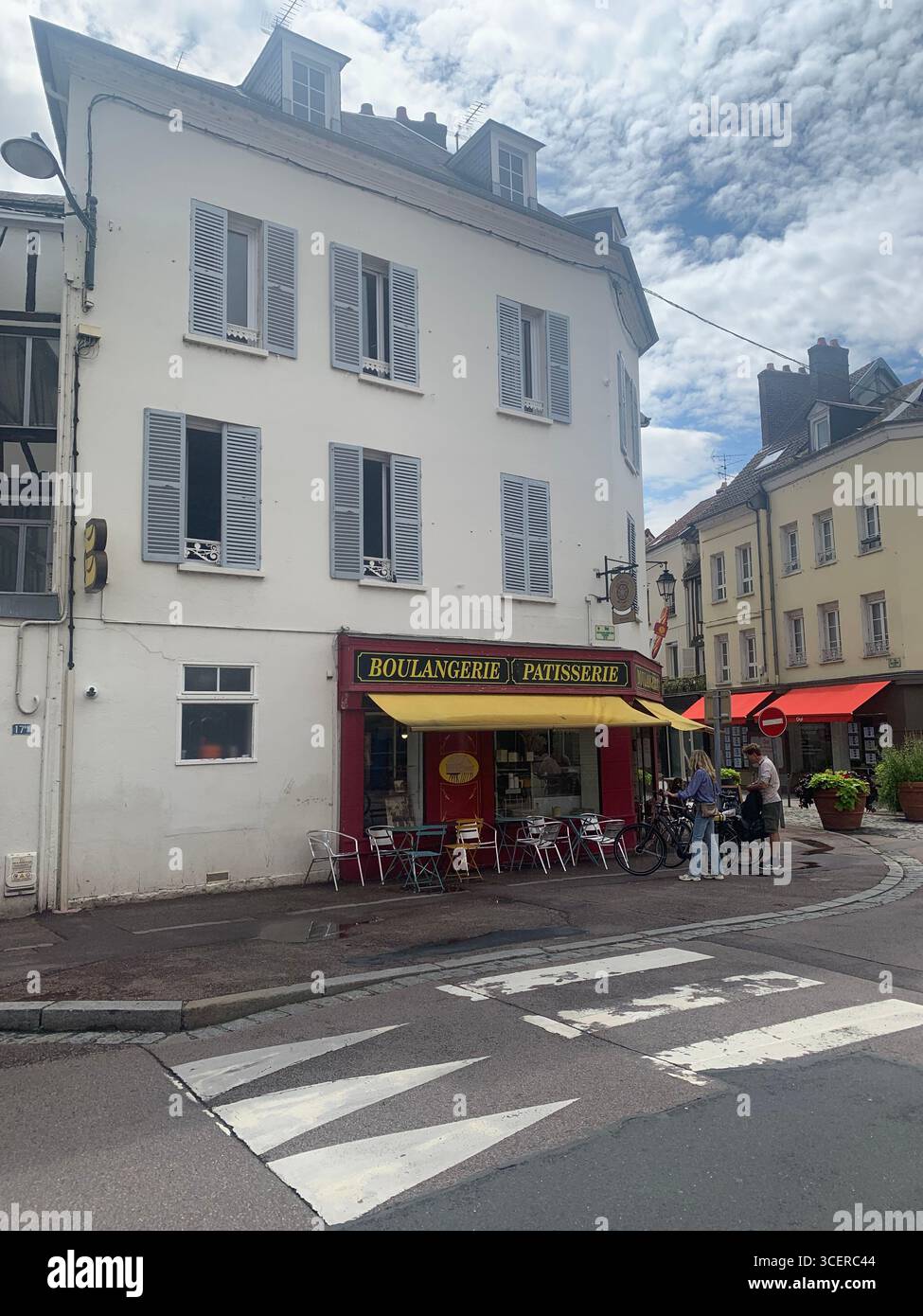 Vernon France shops shop tourists village town locals people cobbles cobbled restaurant eating food old style houses polar bear artwork sign signs - Smartphone Captured Stock Image