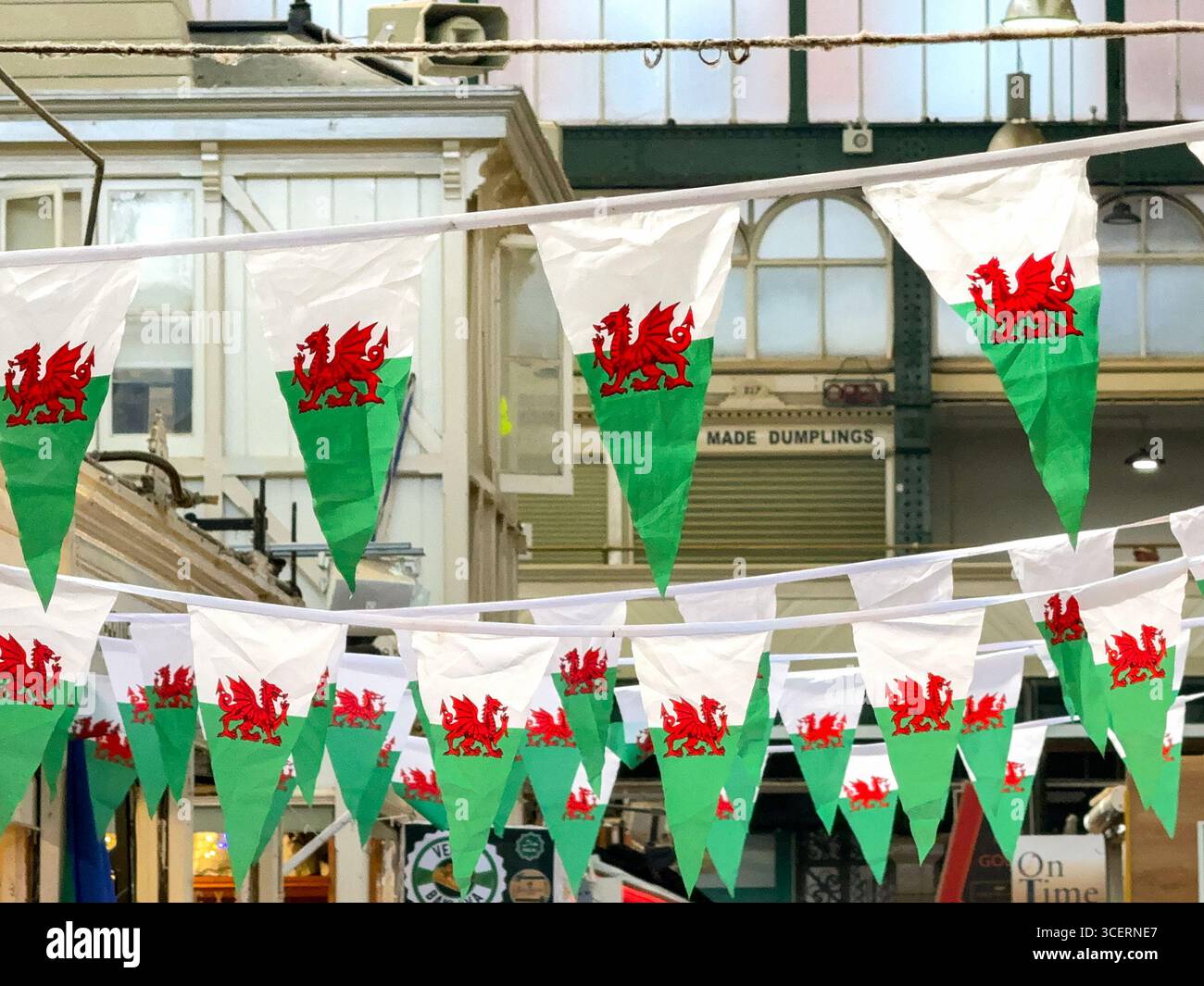 Cardiff, Wales, UK - 15 August 2025: Welsh flags hanging in the city's traditional indoor market in the city centre. - Smartphone Captured Stock Image
