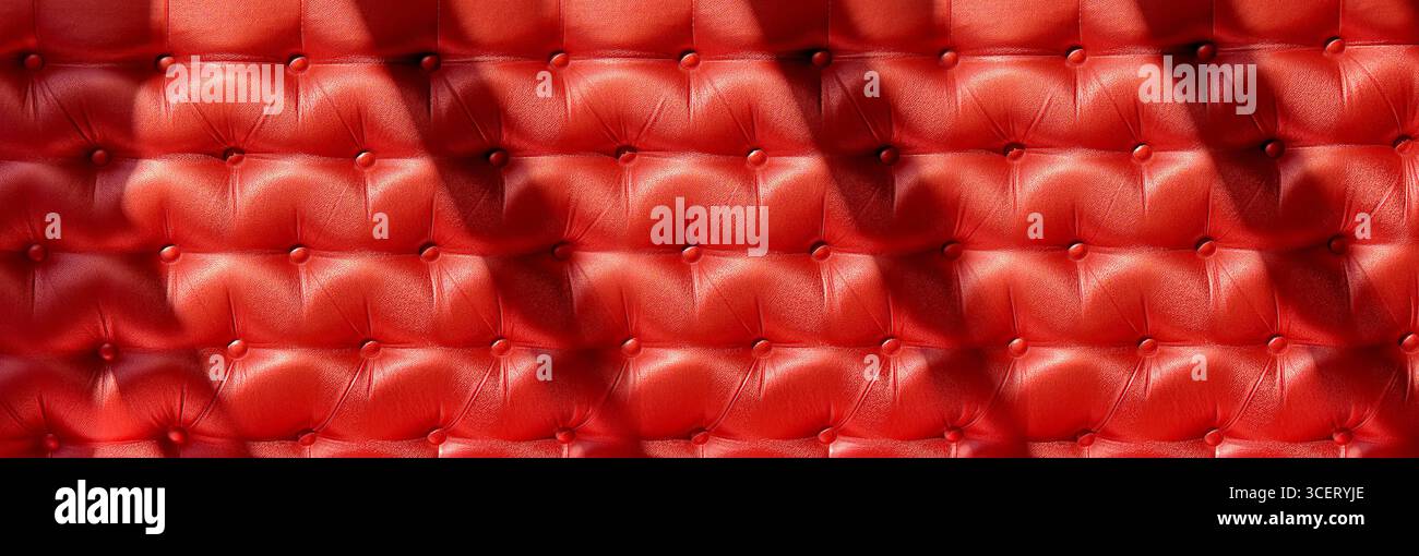 Red upholstery background creating a luxurious, elegant and classic pattern, ideal for interior design projects Stock Photo