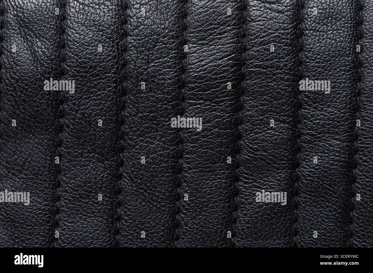 Black leather surface with stitches macro close up view Stock Photo
