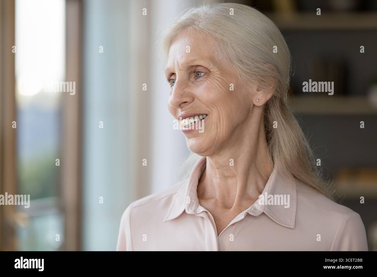 Portrait happy beautiful smiling older woman posing indoors looking ...