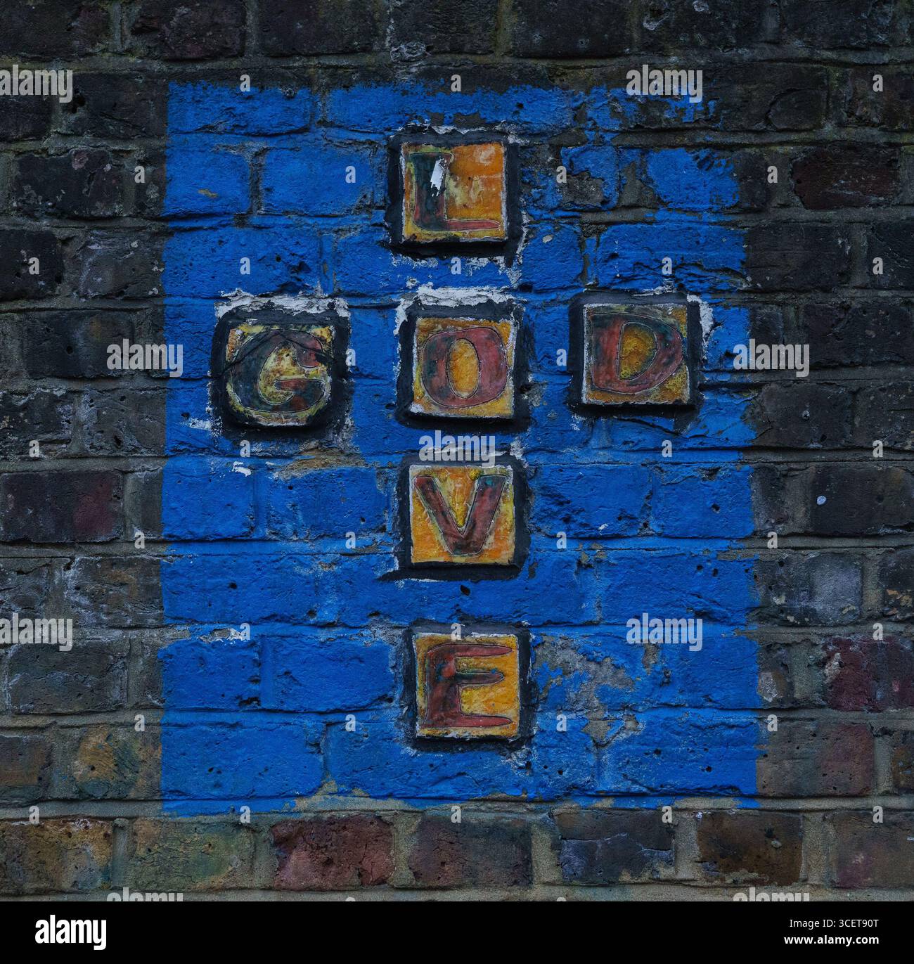'God is Love' - artwork seen on the side of St Michaels church, Camden, London, UK Stock Photo